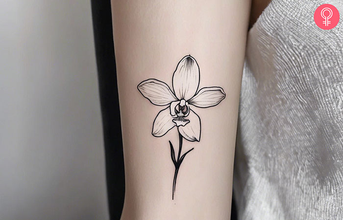 A woman with a white orchid tattoo on her arm