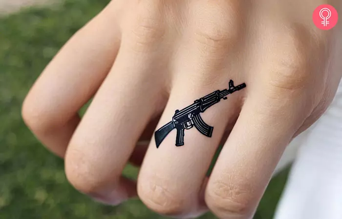 A woman with an AK-47 finger tattoo