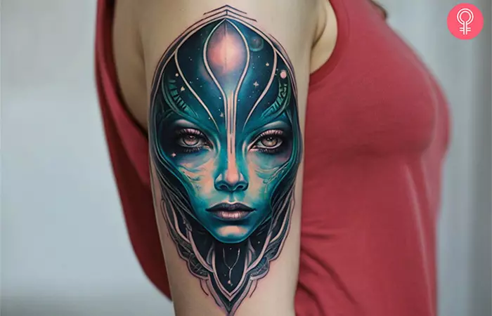 A woman with an alien face tattoo on her upper arm