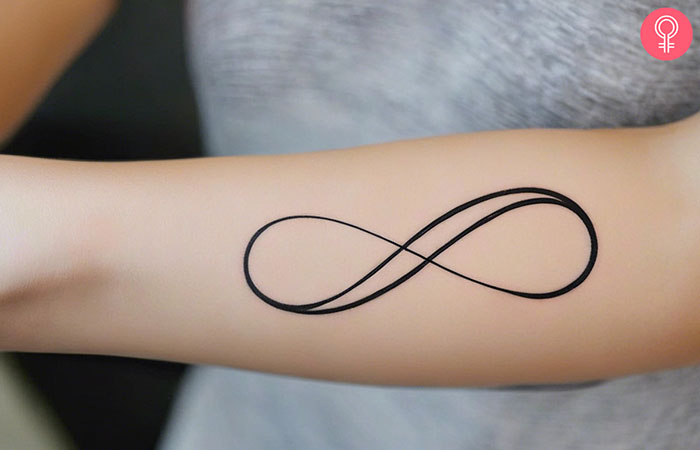 A woman with an infinity tattoo design on her forearm