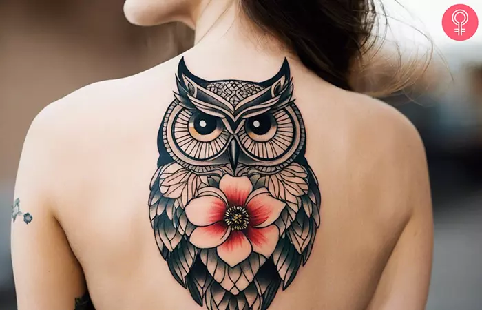 A woman with an owl and flower tattoo on her upper back
