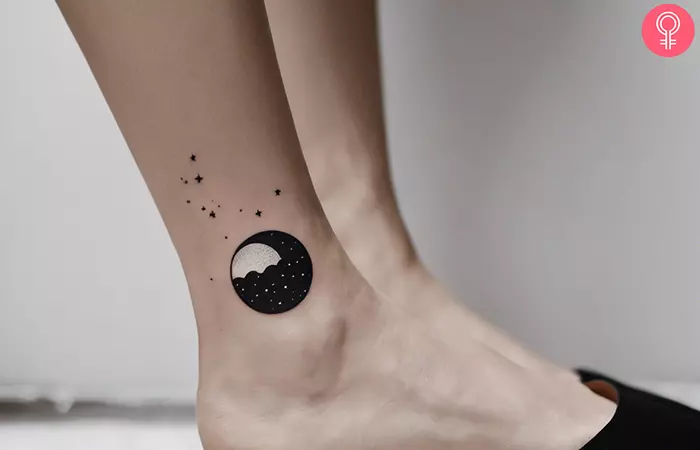 A woman with black and white night sky tattoo on her ankle