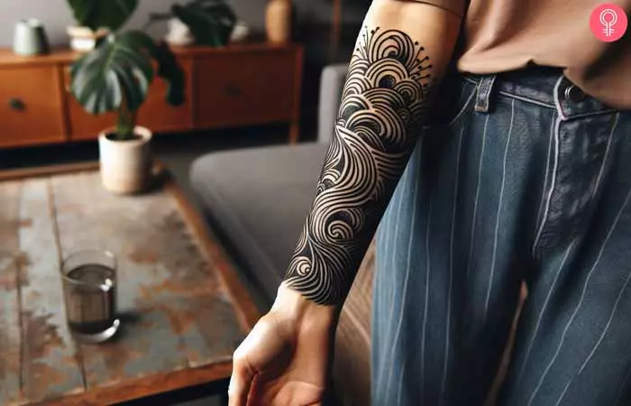  woman with an abstract blackwork tattoo design on her forearm 