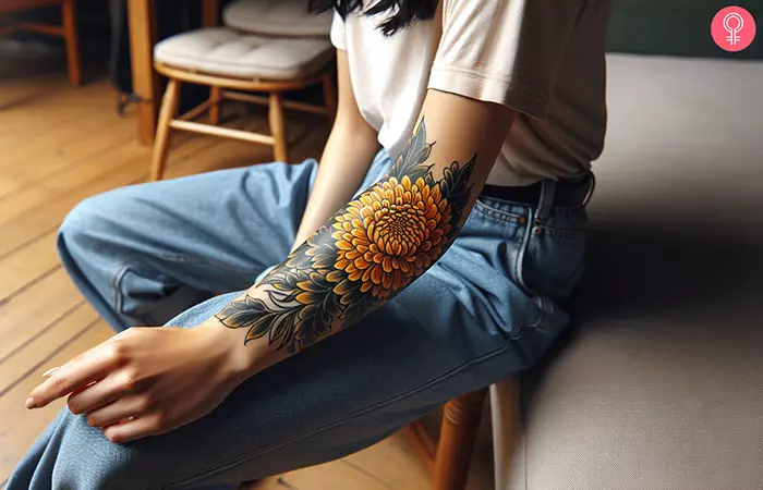 A woman with yellow chrysanthemum tattoo on her forearm