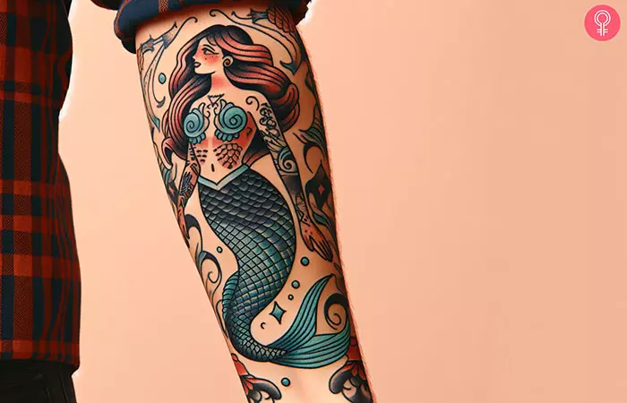 Woman with American traditional mermaid tattoo on her forearm