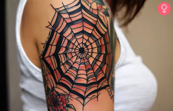 An American traditional spider web tattoo on the upper arm
