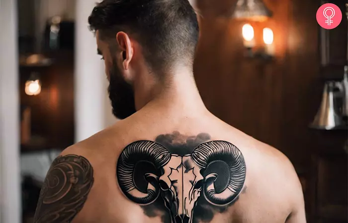 An Aries skull tattoo on the back of a man