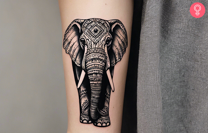 An elephant good luck tattoo on the upper arm