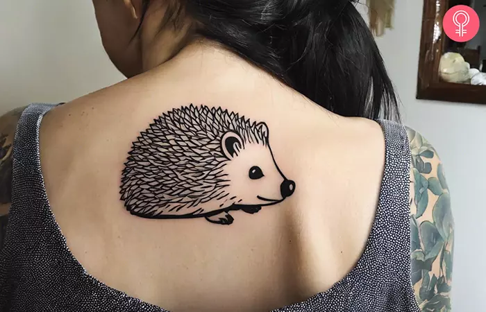An hedgehog outline tattoo design on the upper back