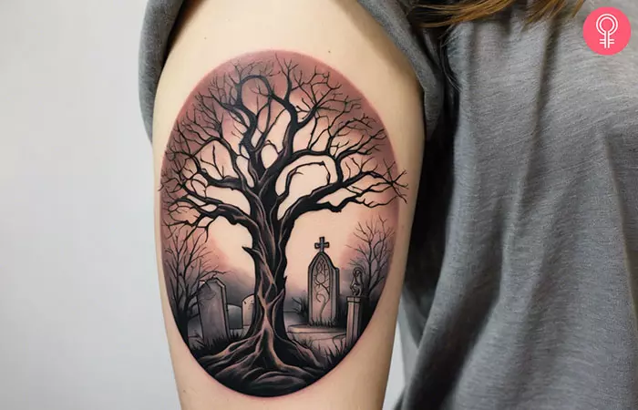 An upper arm tree graveyard tattoo