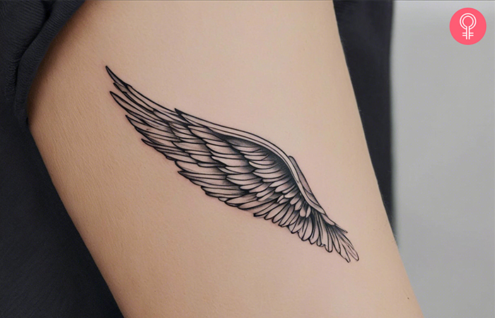 An angel wings tattoo design on the upper arm