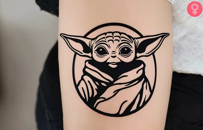 Baby Yoda simple tattoo on the upper arm