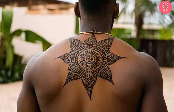 A black man sporting a back tattoo