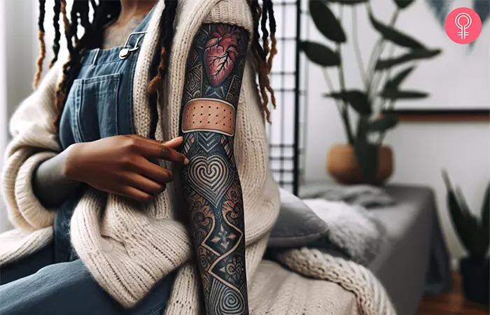A woman sporting a band-aid sleeve tattoo with a heart
