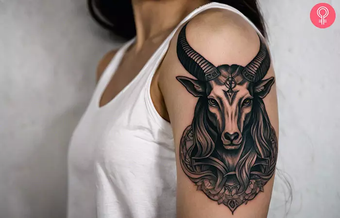 Woman with a Baphomet tattoo on the upper arm