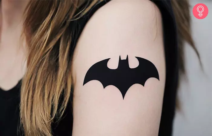 A Batman logo tattoo on the upper arm