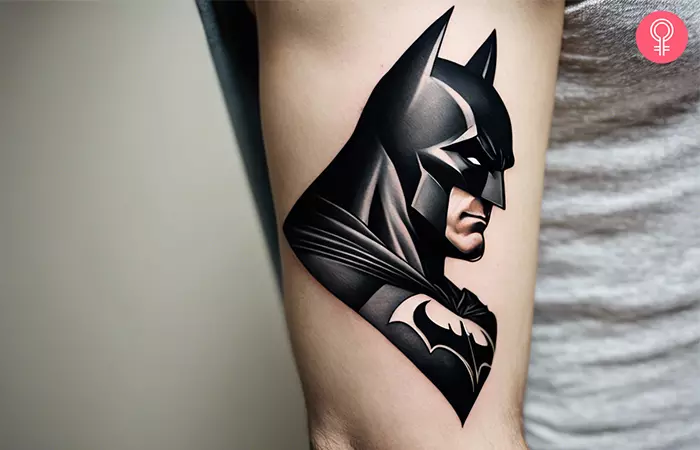 Tattoo of Batman on the upper arm of a woman