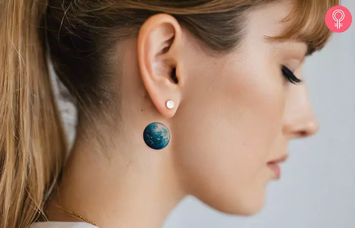 A realistic Earth tattoo on the back of the ear