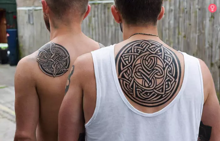 Two men sporting big brother little brother tattoos
