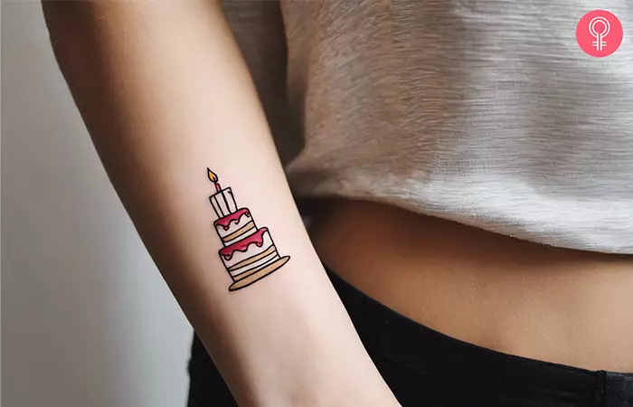 Birthday cake tattoo on forearm