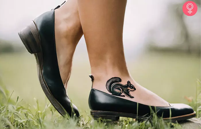 A black and white squirrel tattoo on the ankle