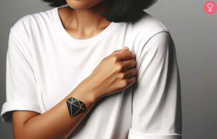 A woman with a black diamond tattoo on her arm