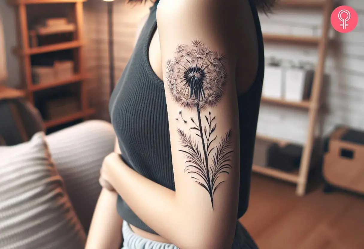 Black and white dandelion tattoo on the upper arm