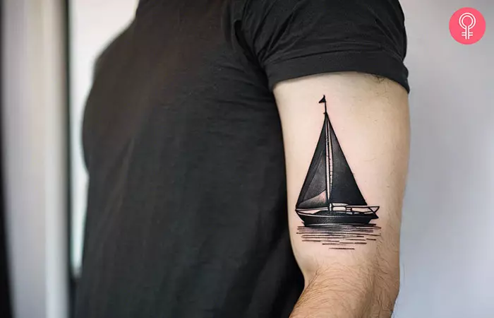 Man with blackwork sailboat tattoo on his arm