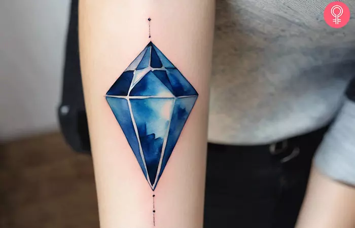 A woman with a blue diamond tattoo on her arm