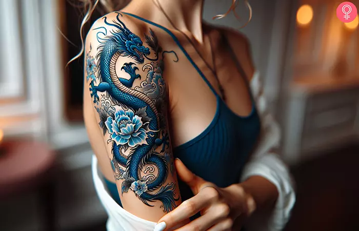 Blue Japanese water dragon tattoo on the arm of a woman