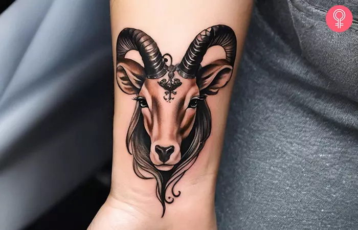 Woman with Capricorn zodiac sign tattoo on her wrist