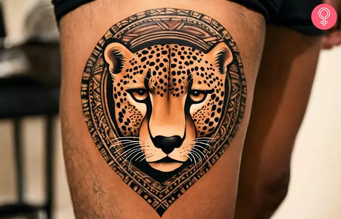 Cheetah face tattoo on a man’s thigh