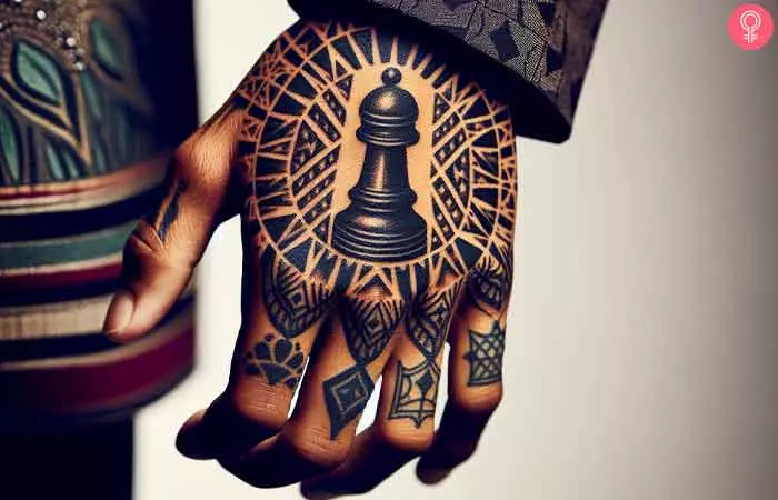 A chess piece tattoo with tribal design on the hand of a woman