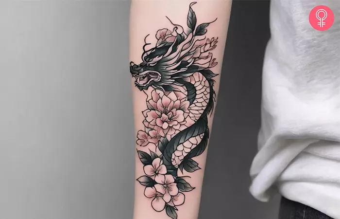 Chinese dragon tattoo with flowers on the arm