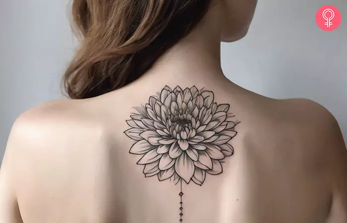 A chrysanthemum fine line tattoo on a woman’s back