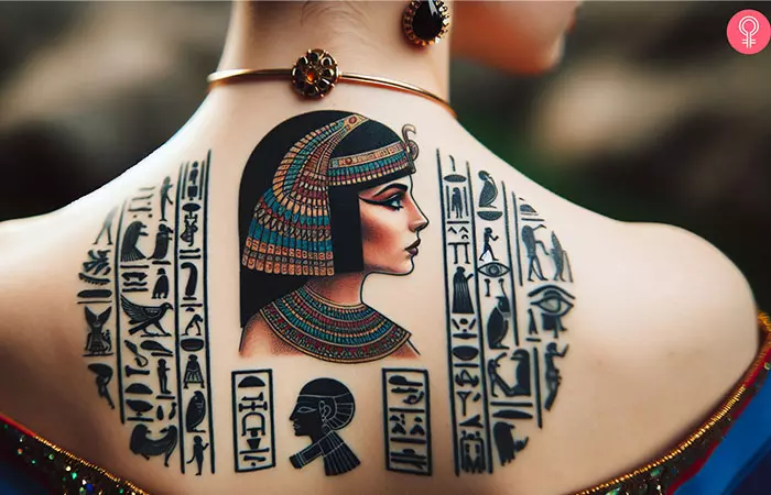 An upper back tattoo of Cleopatra and hieroglyphics