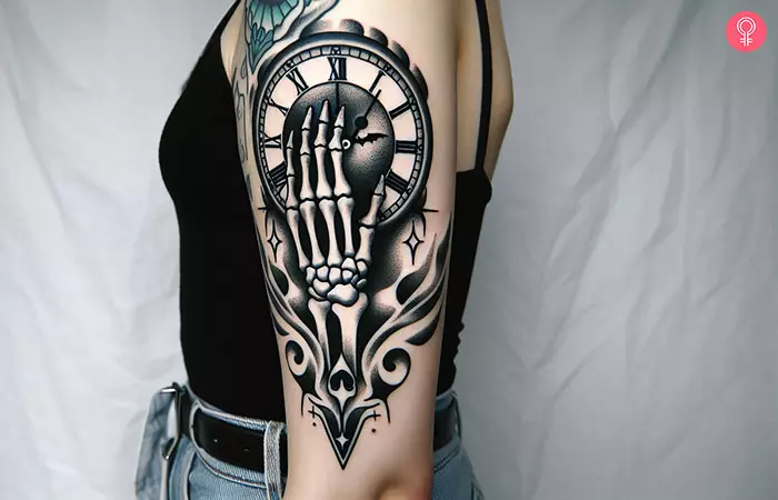 A skeletal hand holding a clock arm tattoo