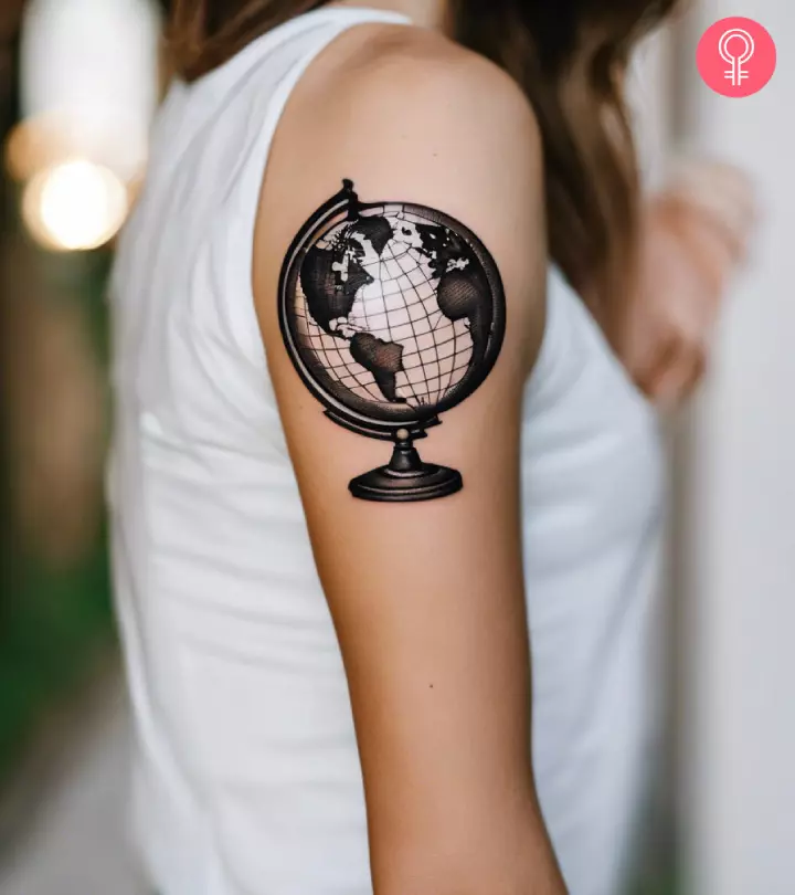 Close-up of a globe tattoo on the arm of a woman