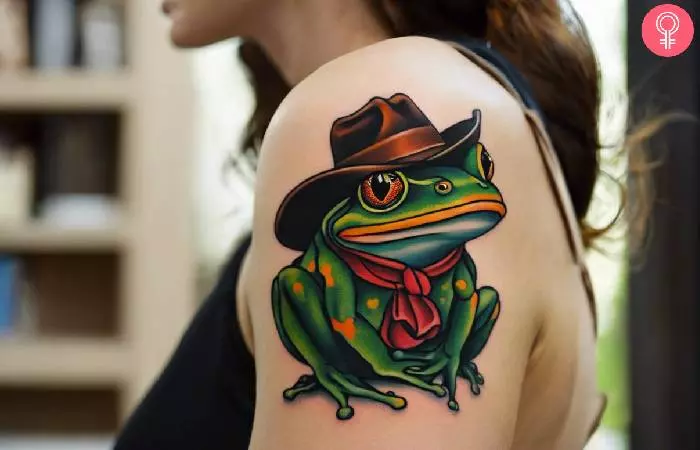 Cowboy frog tattoo on a woman’s upper arm