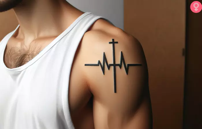 A man sporting a cross heartbeat tattoo on the upper arm
