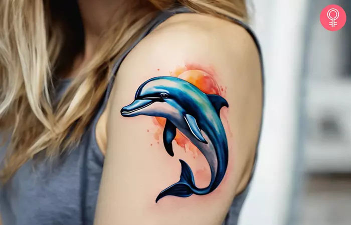 Cute dolphin tattoo on the upper arm