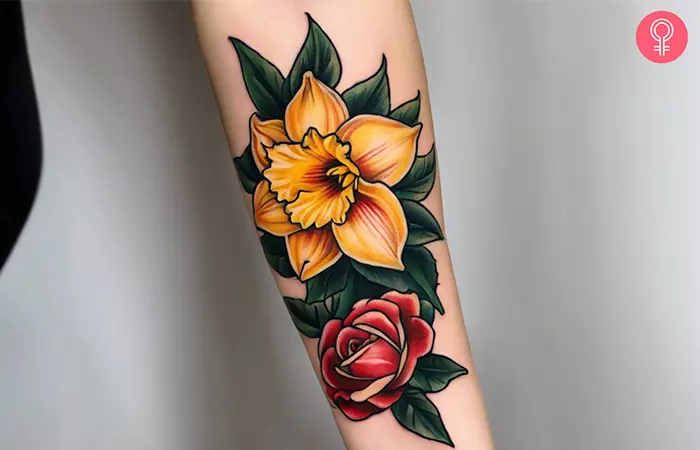  A colorful daffodil and rose tattoo on the forearm