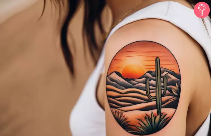 A woman with a desert landscape tattoo on her upper arm