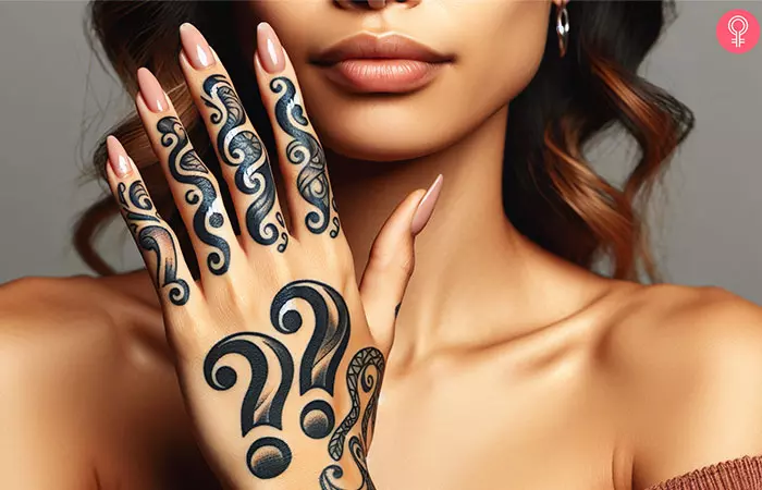 A double question mark tattoo on the hand of a woman