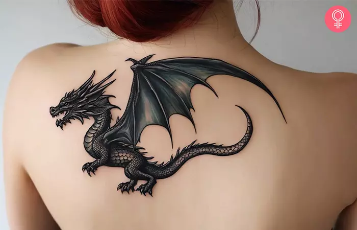 A woman with a dragon tattoo on her upper back