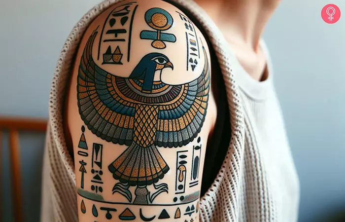 Tattoo of Horus and hieroglyphics on the upper arm