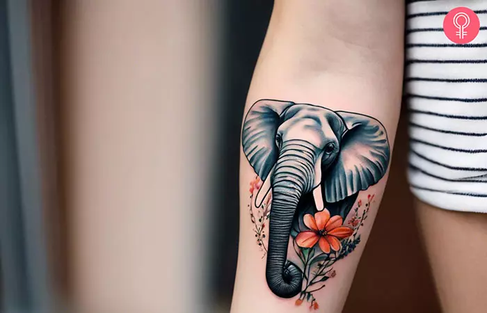 Elephant tattoo with pink flowers
