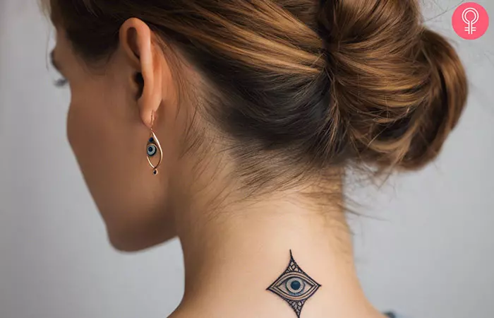 Evil eye tattoo on the back of a woman’s neck