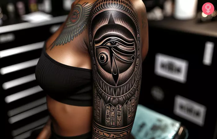 An hieroglyphics and eye of Horus tattoo on the upper arm