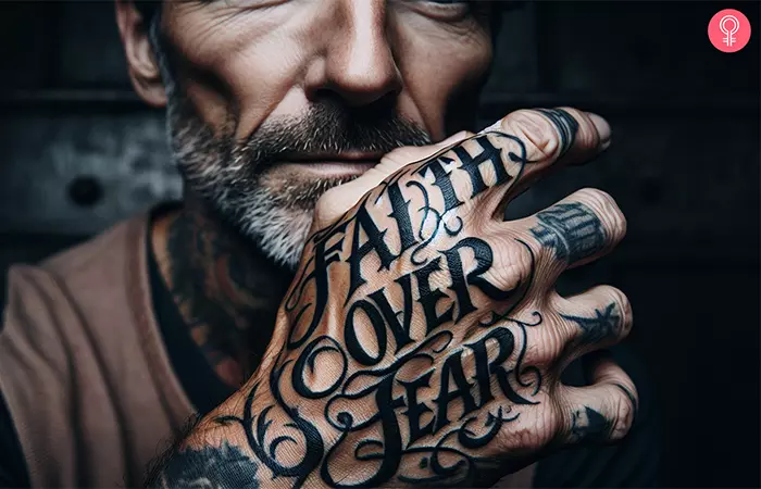 A man with a faith over fear hand tattoo